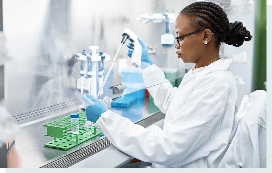 Scientist putting liquid from dropper in test tube